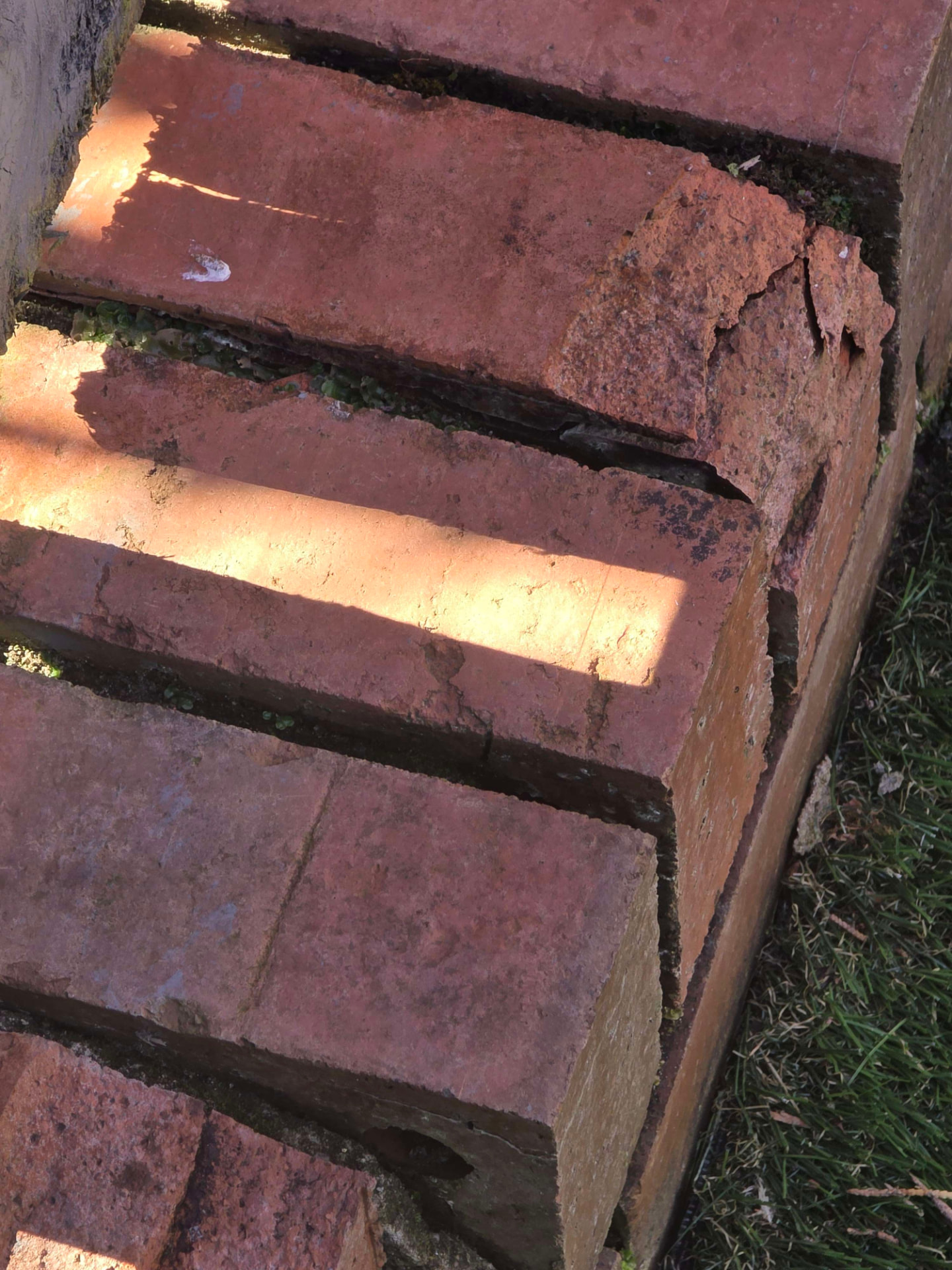Spalled red bricks cut out and replaced with new brickwork